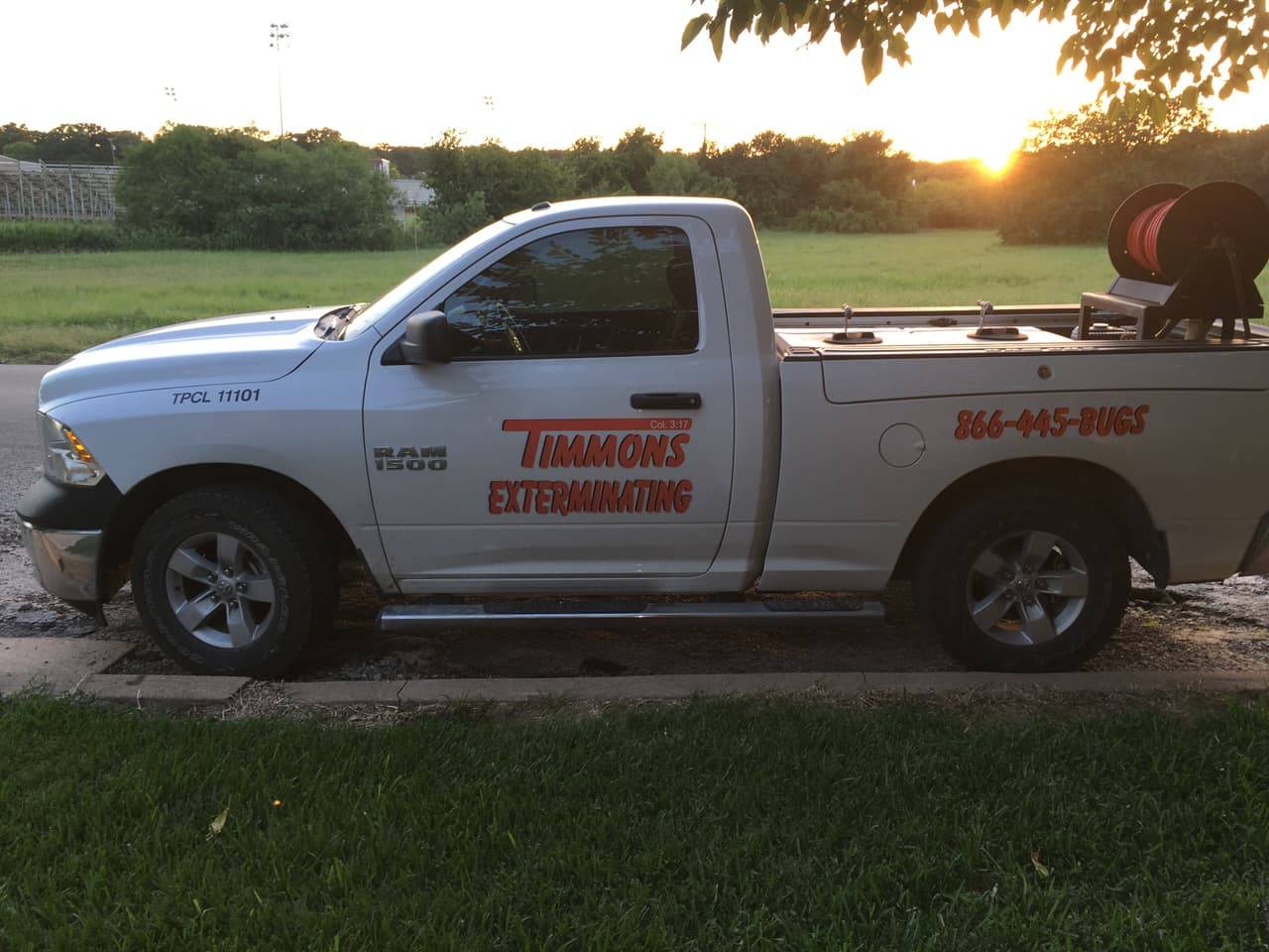 Timmons Exterminating service truck with spray equipment parked at sunset in Central Texas